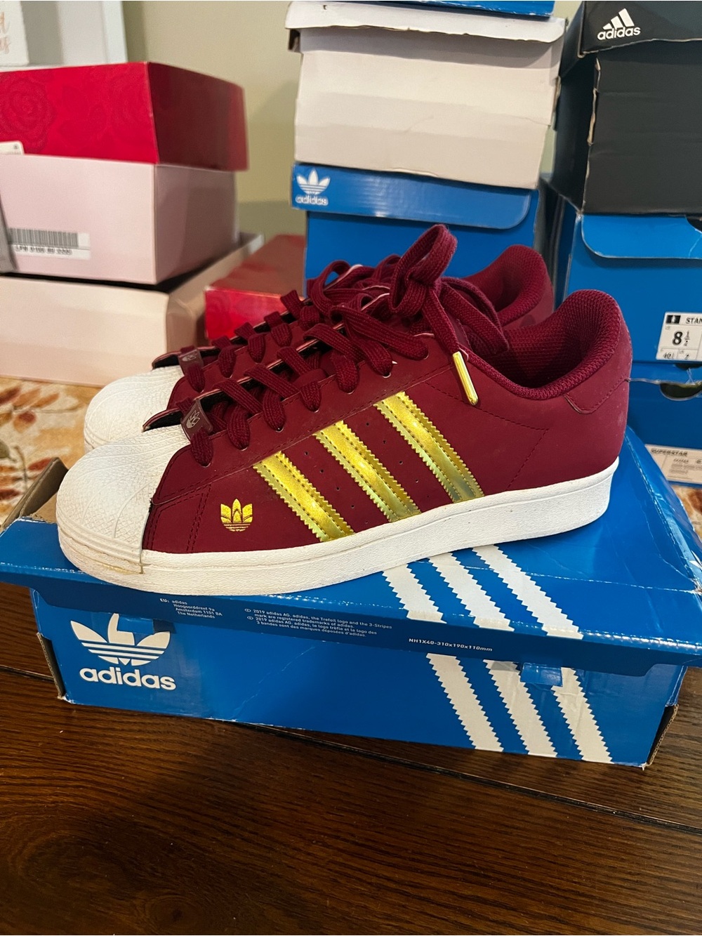 adidas woman’s Burgundy Sneakers with Gold Stripes